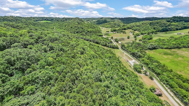 drone / aerial view featuring a wooded view