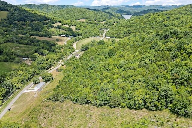 birds eye view of property featuring a view of trees