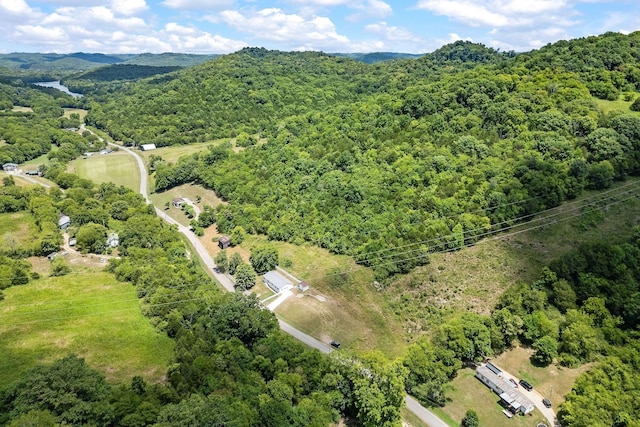 drone / aerial view featuring a forest view