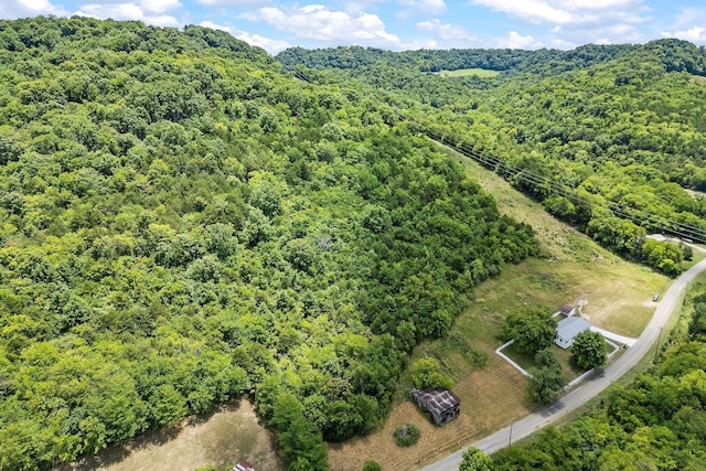 birds eye view of property with a view of trees