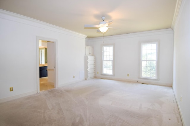 unfurnished room with light colored carpet, baseboards, and ornamental molding