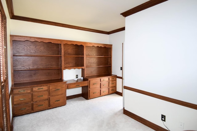 unfurnished office with crown molding, baseboards, and light carpet