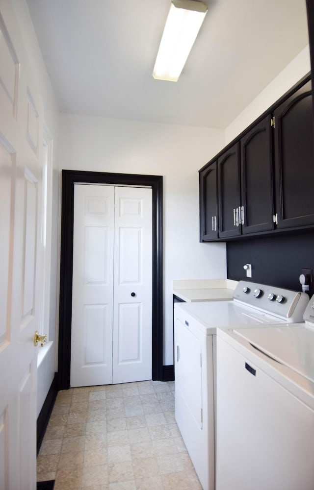 washroom featuring cabinet space, independent washer and dryer, and baseboards