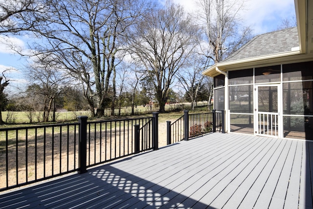 wooden deck featuring a fenced backyard and a sunroom