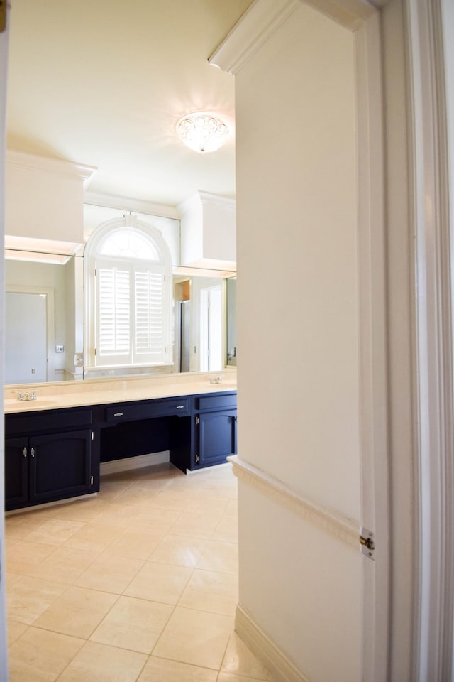 bathroom featuring vanity, a shower stall, tile patterned flooring, and ornamental molding