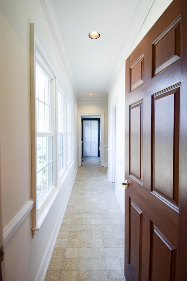 hallway featuring recessed lighting, baseboards, and ornamental molding