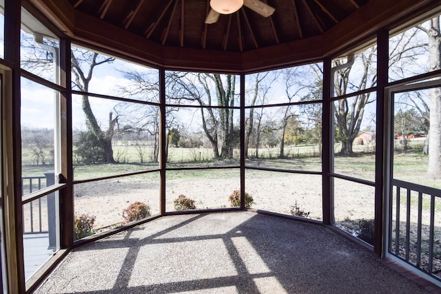 unfurnished sunroom with a ceiling fan