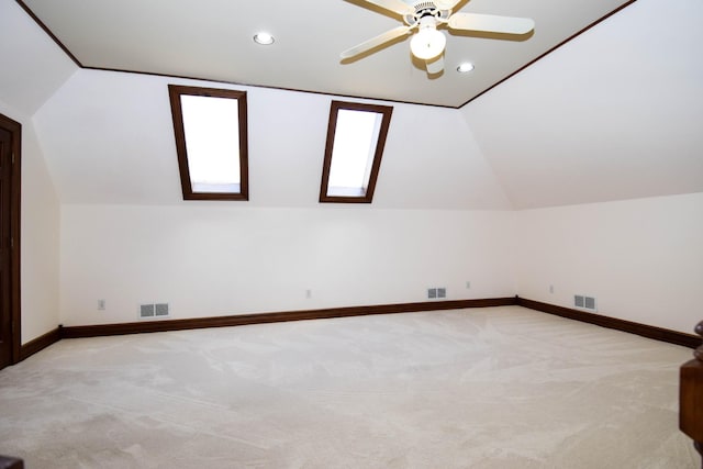 additional living space with visible vents, light carpet, and lofted ceiling