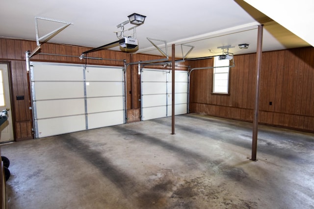 garage featuring wooden walls and a garage door opener