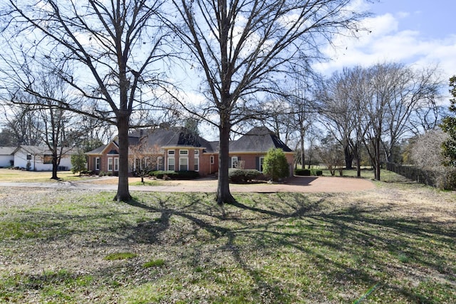 view of front facade with a front yard and brick siding