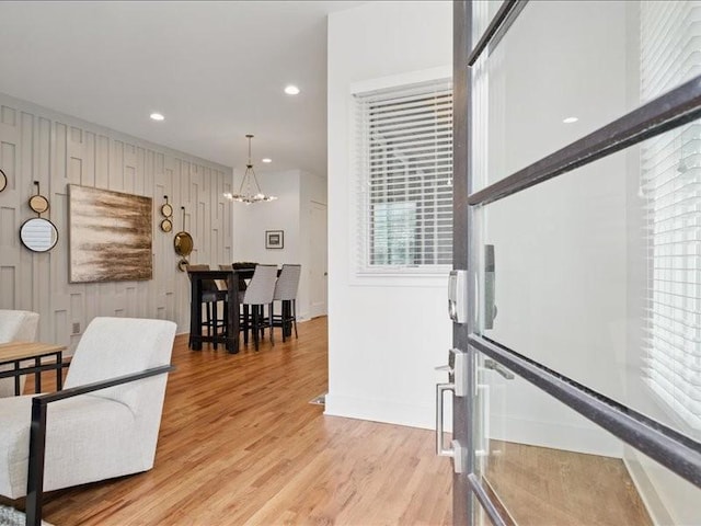 interior space featuring light wood finished floors, recessed lighting, baseboards, and an inviting chandelier