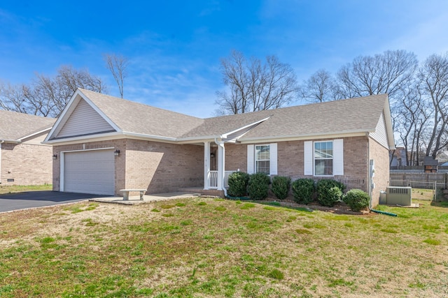 ranch-style house featuring cooling unit, fence, driveway, a garage, and brick siding