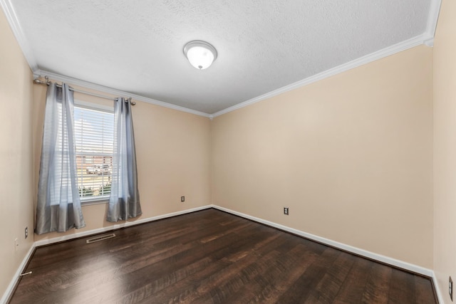 empty room featuring dark wood finished floors, crown molding, baseboards, and visible vents