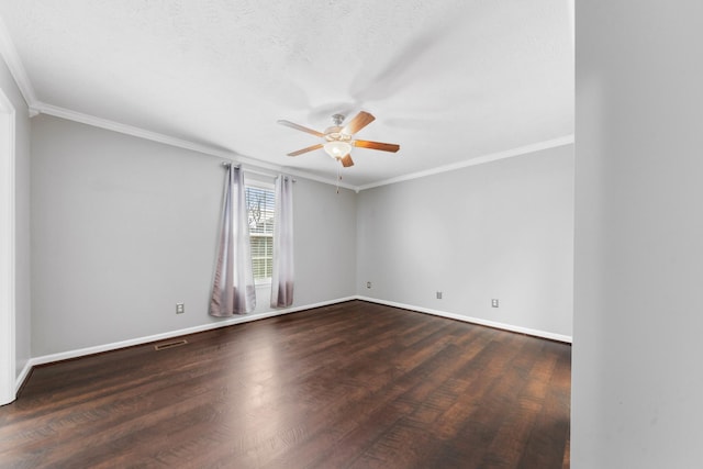 spare room featuring baseboards, wood finished floors, and crown molding