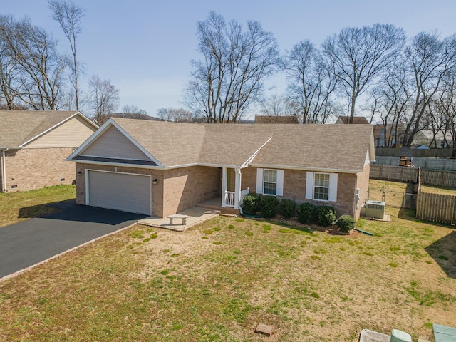 ranch-style home featuring brick siding, aphalt driveway, fence, and a garage