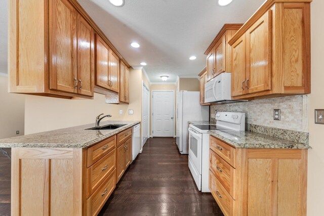 kitchen featuring crown molding, decorative backsplash, dark wood-style floors, white appliances, and a sink