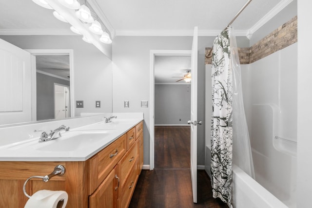 bathroom featuring crown molding, wood finished floors, double vanity, and a sink