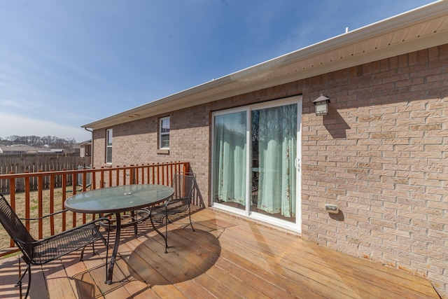 wooden deck with outdoor dining space and fence