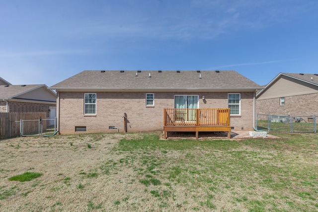 rear view of house featuring brick siding, a lawn, a deck, crawl space, and a gate