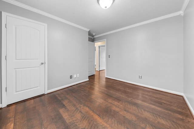 unfurnished room with ornamental molding, baseboards, and wood finished floors