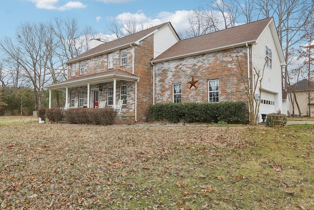 view of front of property featuring brick siding, covered porch, a chimney, a garage, and stone siding