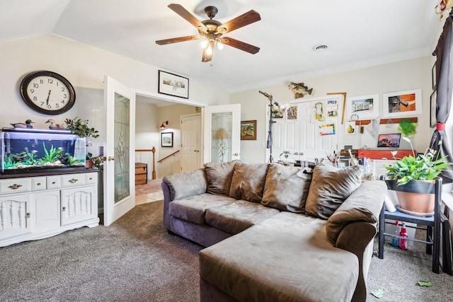 living area with a ceiling fan, vaulted ceiling, carpet flooring, and french doors