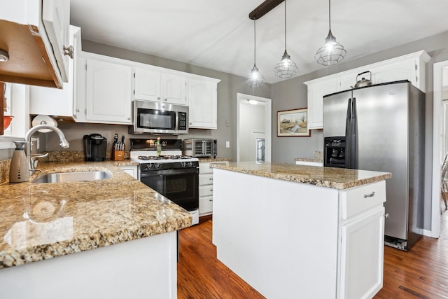 kitchen with a kitchen island, dark wood-style flooring, a sink, appliances with stainless steel finishes, and white cabinetry