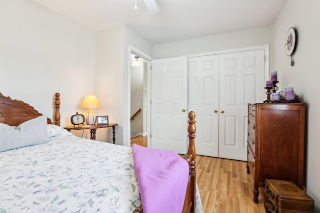 bedroom featuring a closet, light wood-style floors, and ceiling fan