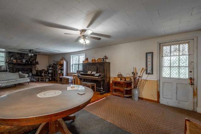 dining space featuring a fireplace and ceiling fan