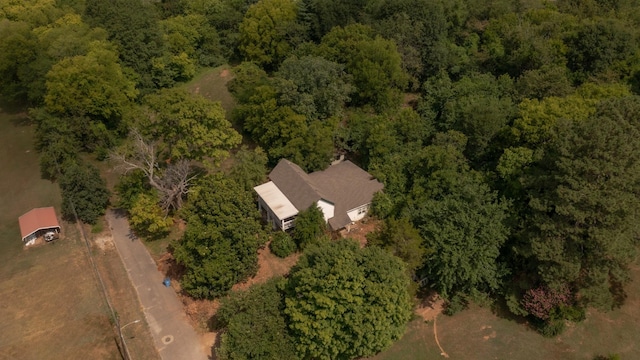 drone / aerial view with a wooded view
