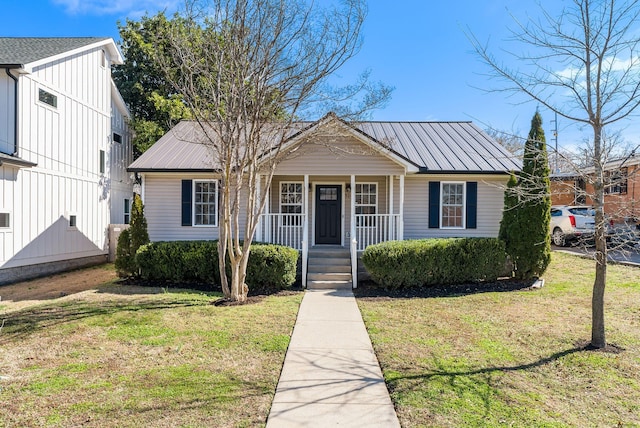 bungalow-style home with a porch, a front yard, and metal roof