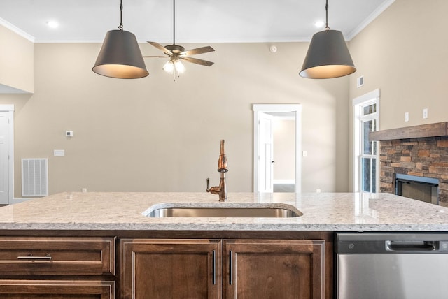 kitchen featuring a sink, visible vents, dark brown cabinetry, and dishwasher