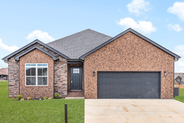 ranch-style house featuring a garage, roof with shingles, concrete driveway, and a front lawn