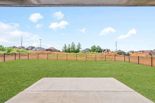 view of yard with a fenced backyard, a residential view, and a patio