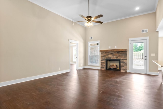 unfurnished living room with visible vents, a healthy amount of sunlight, crown molding, and dark wood-style flooring