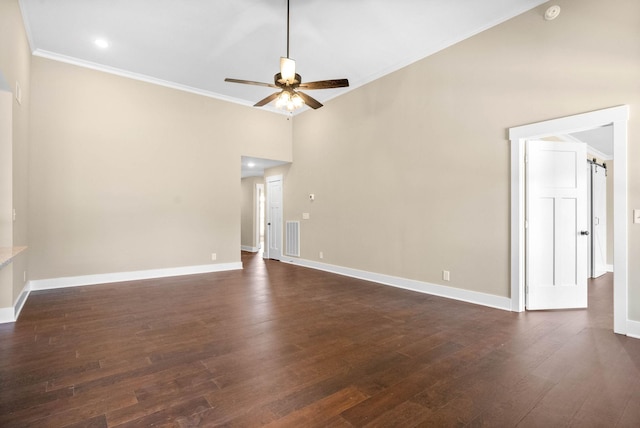 spare room with visible vents, a ceiling fan, crown molding, baseboards, and dark wood-style flooring