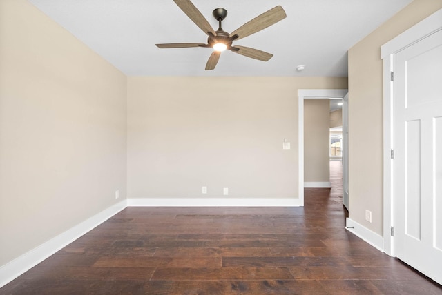 unfurnished room with a ceiling fan, baseboards, and wood finished floors