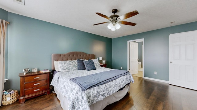 bedroom with visible vents, connected bathroom, ceiling fan, baseboards, and dark wood-style floors