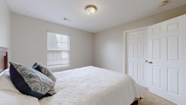 carpeted bedroom with visible vents