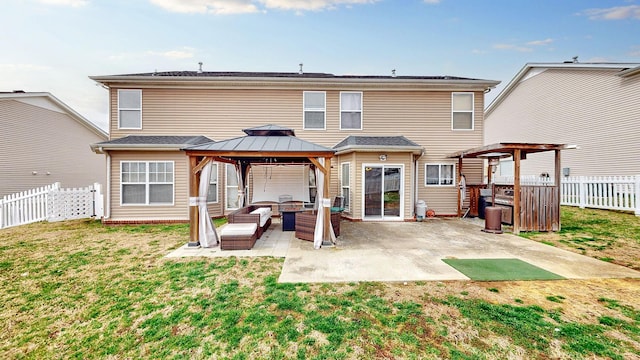 back of house with a gazebo, a lawn, a fenced backyard, and a patio area