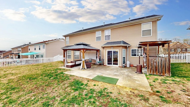 back of house featuring a gazebo, a fenced backyard, a lawn, and a patio