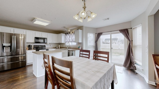 dining room with visible vents, baseboards, dark wood-type flooring, and an inviting chandelier