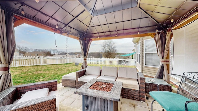 view of patio / terrace with an outdoor living space with a fire pit, a gazebo, and a fenced backyard