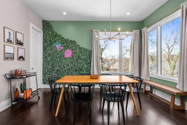 dining area featuring baseboards, plenty of natural light, and dark wood-style floors