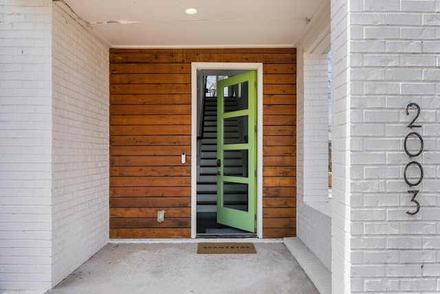 property entrance featuring brick siding