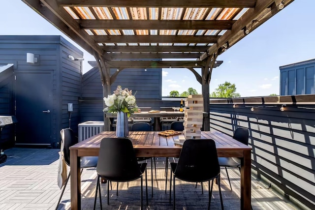 view of patio featuring central AC unit, a pergola, and outdoor dining area