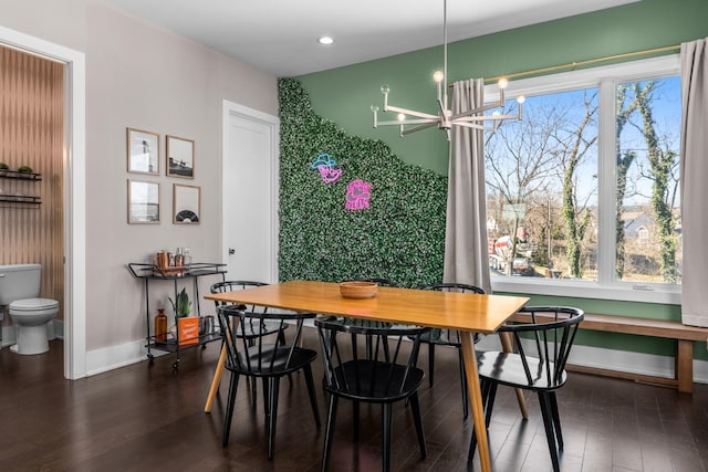 dining space with a chandelier, recessed lighting, dark wood finished floors, and baseboards