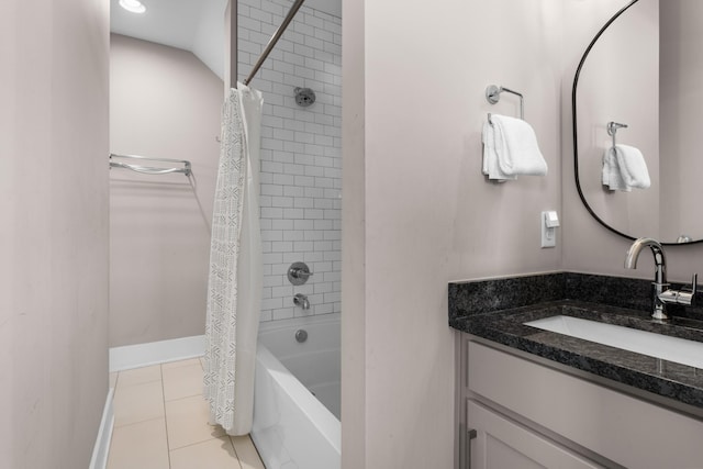 bathroom featuring vanity, tile patterned floors, shower / bath combination with curtain, and baseboards