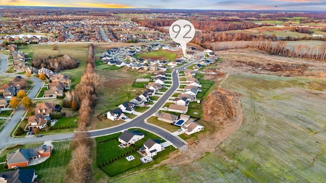 aerial view at dusk featuring a residential view