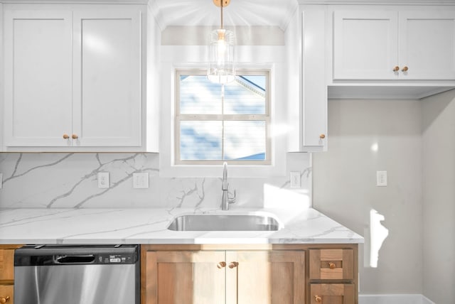 kitchen with a sink, white cabinets, light stone countertops, and stainless steel dishwasher